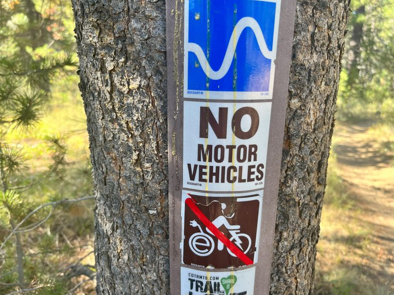 A trailside sign prohibiting motor vehicles from using the trail