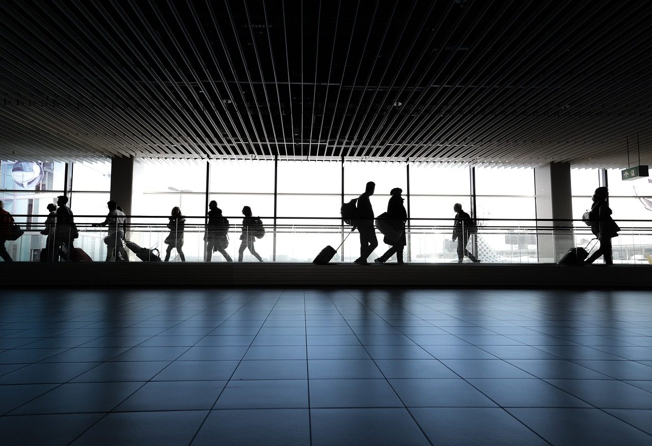 People walking through an airport terminal