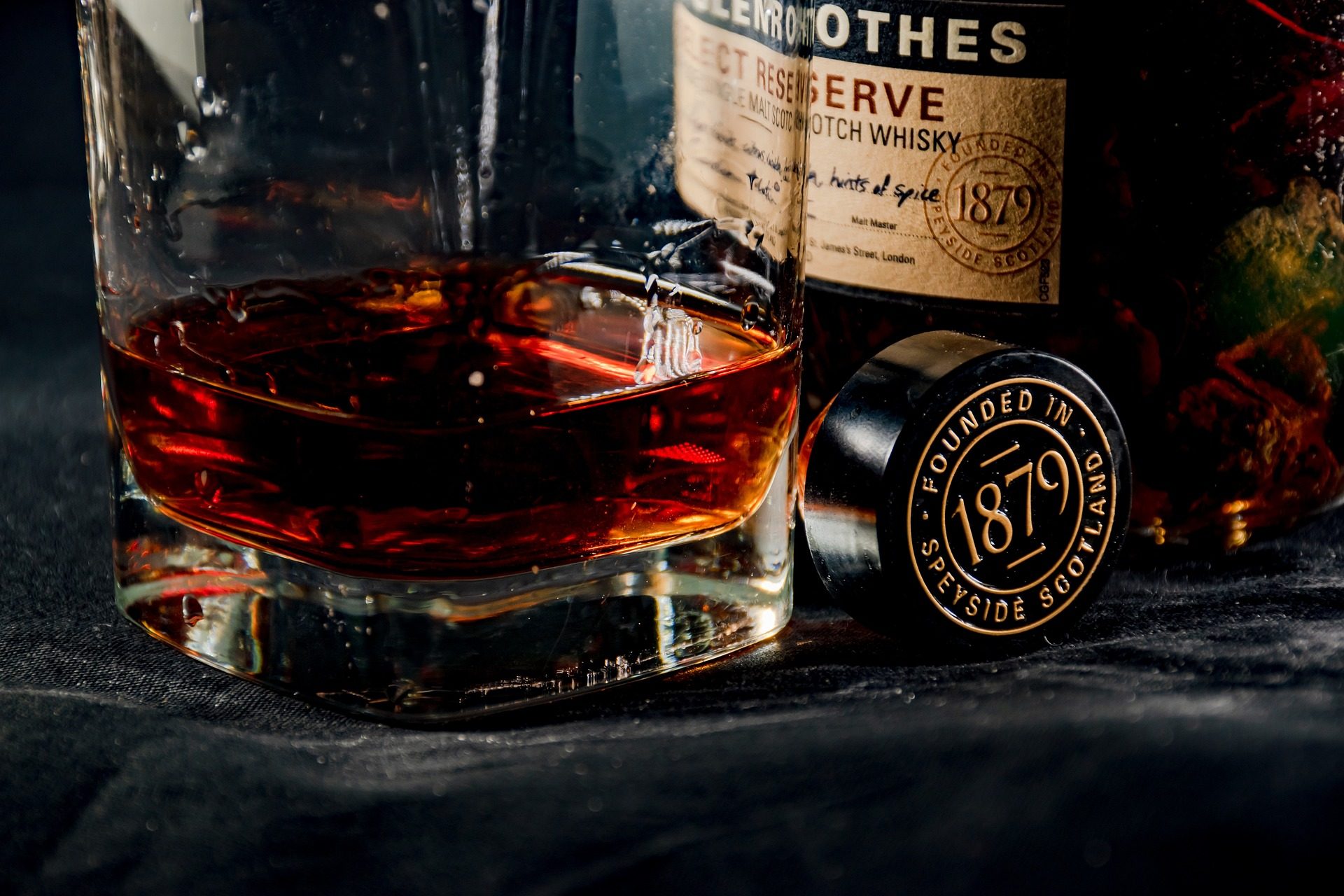 A very dark scotch in front of its bottle