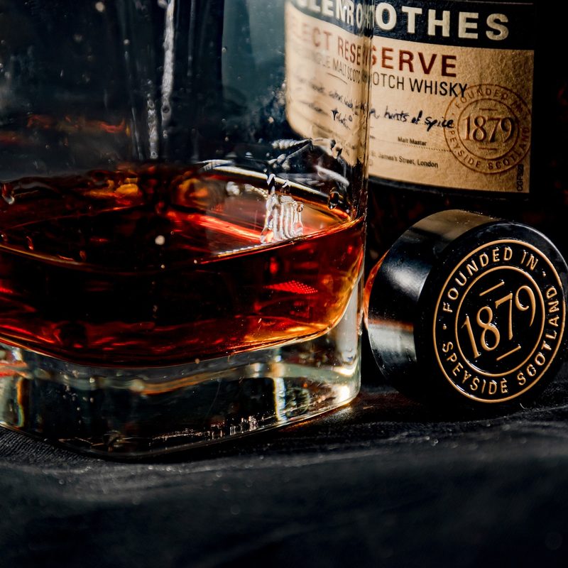 A very dark scotch in front of its bottle