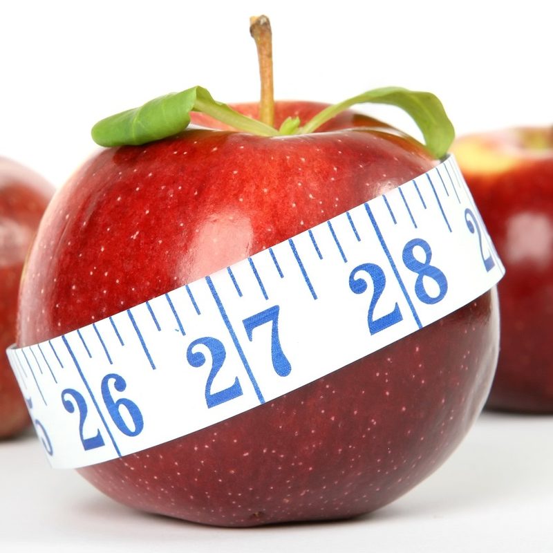 Red apple with measuring tape around it