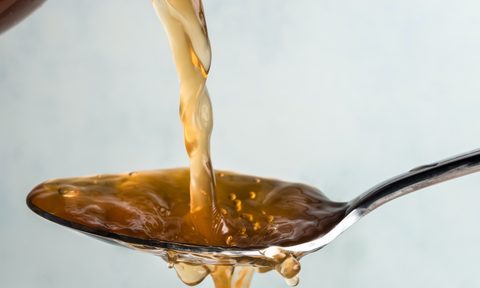 Pouring apple cider vinegar on a spoon