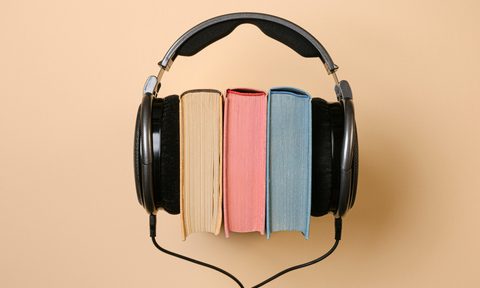 A stack of books with headphones on either side