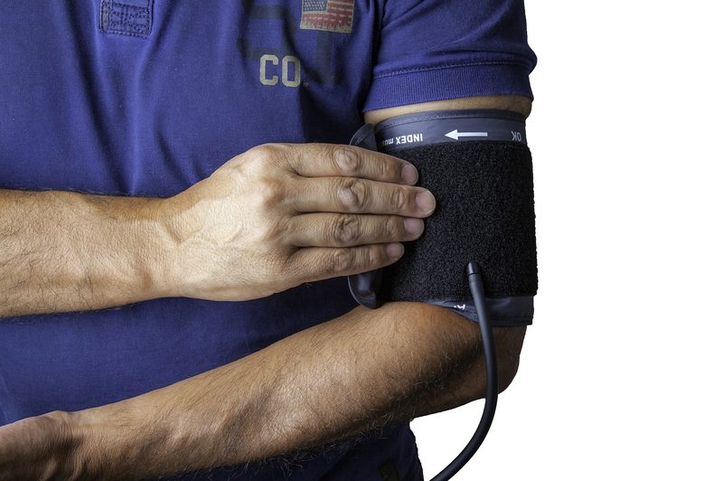 Man with blood pressure cuff around this upper arm