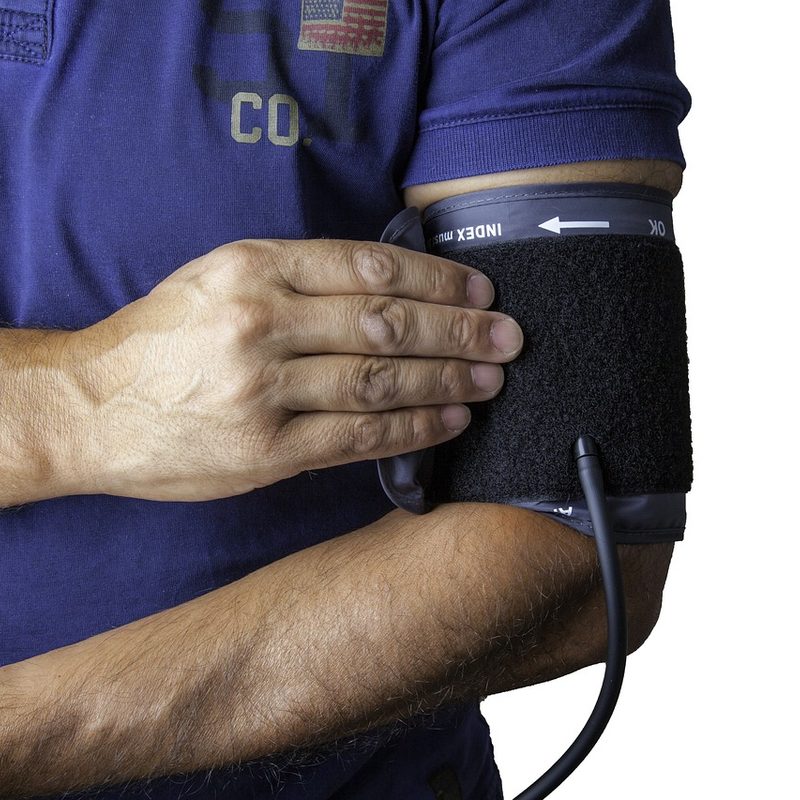 Man with blood pressure cuff around this upper arm
