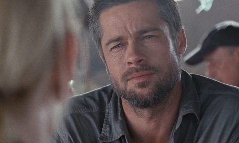 Brad Pitt staring across the table