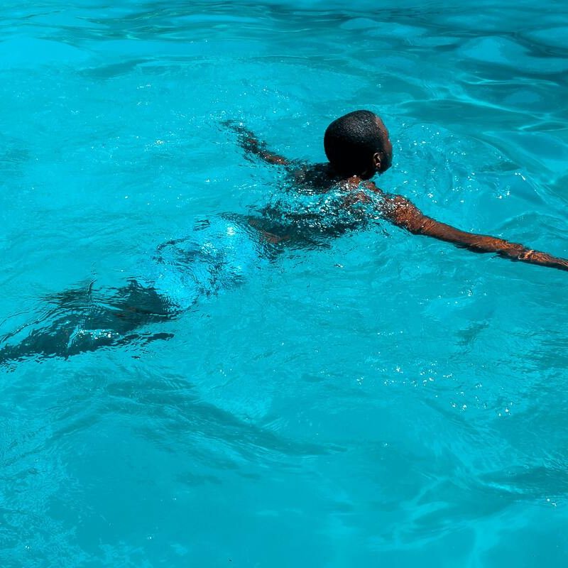 Man swimming in pool.