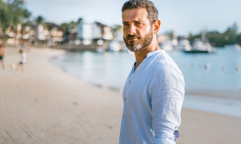 A graying man on a beach