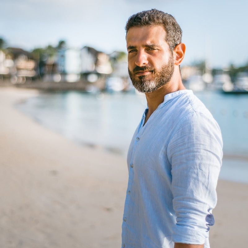 A graying man on a beach