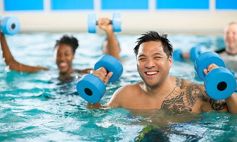 Man in water aerobics class.
