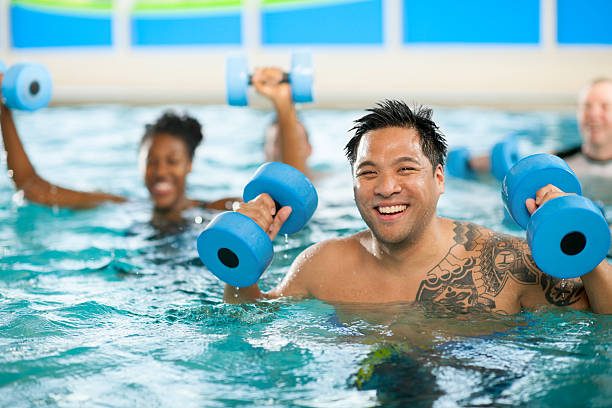 Man in water aerobics class.