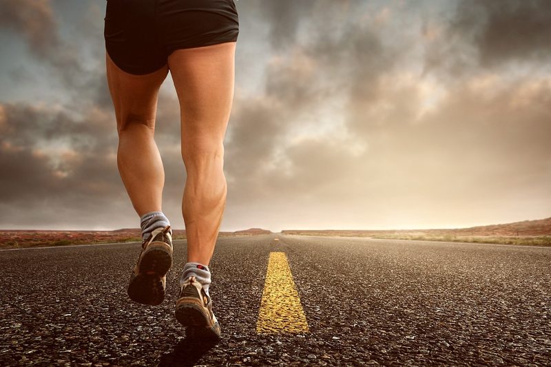 Man running on paved road.