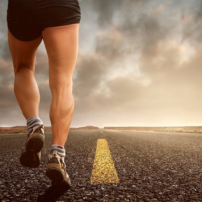 Man running on paved road.
