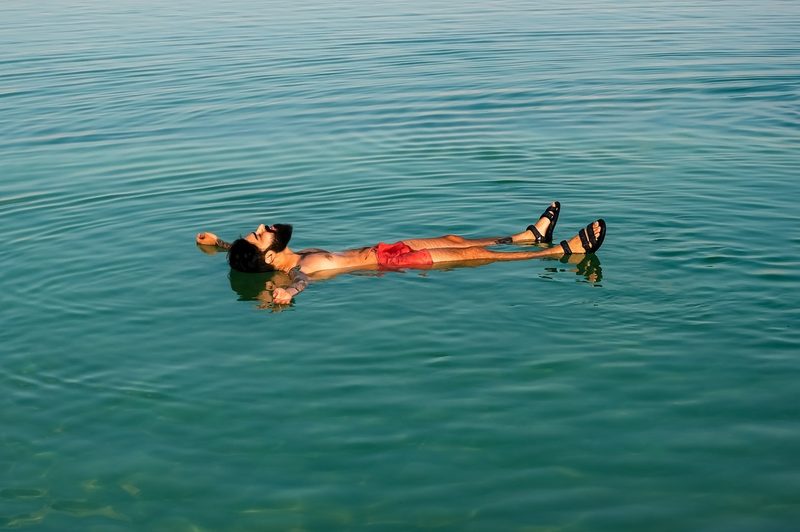 Man floating on his back in the ocean