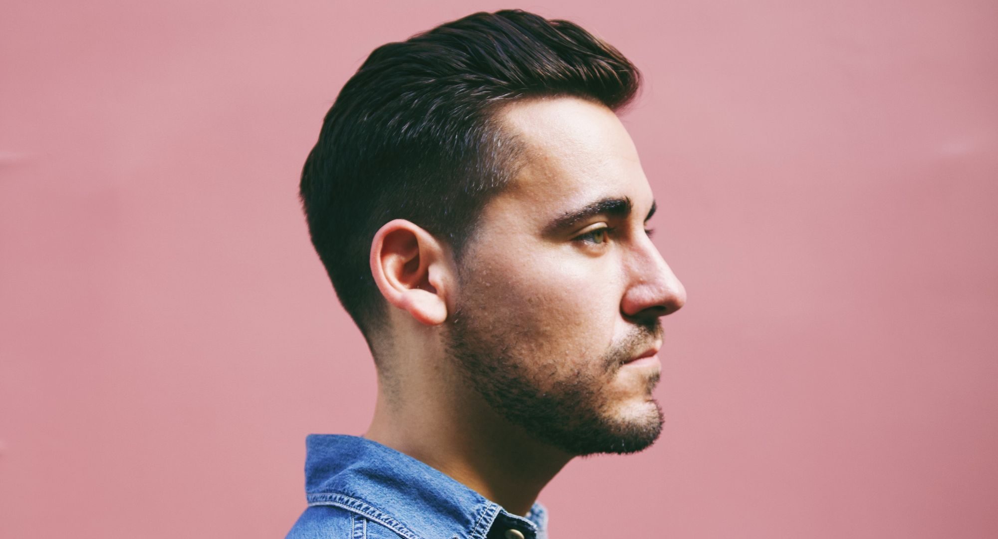 Man standing in front of a pink background