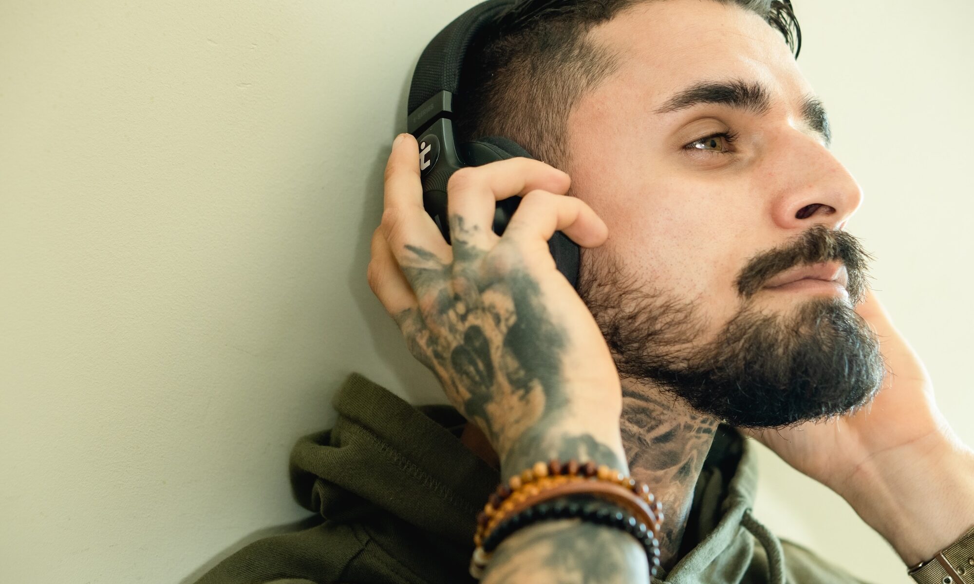 Man holding headphones to his ears