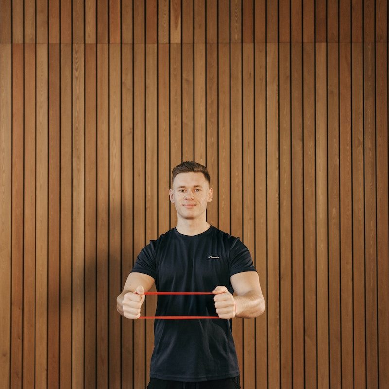 A man with red resitance bands