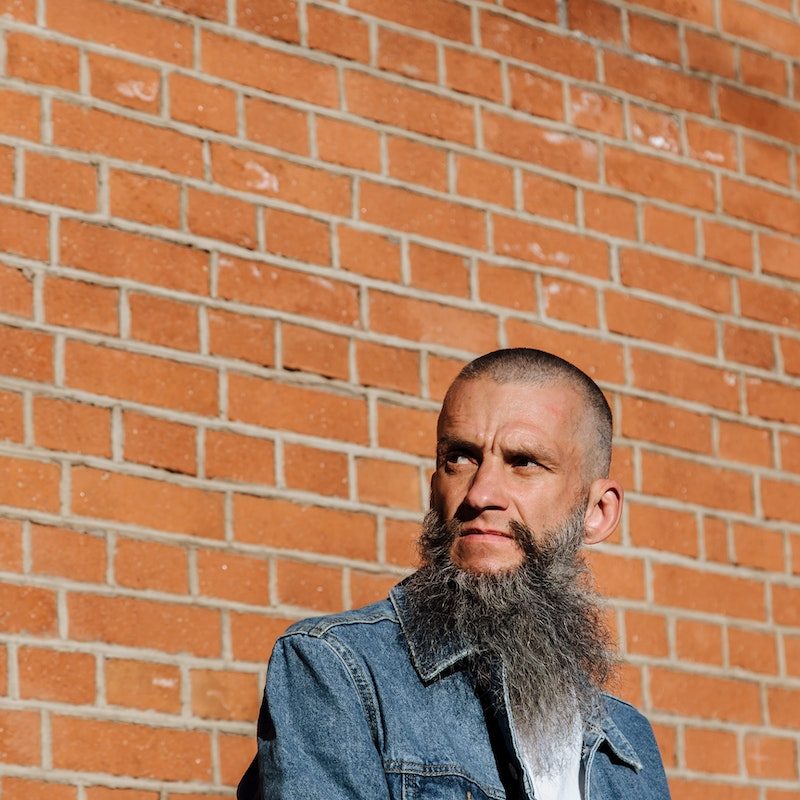 An adult man with a long gray beard