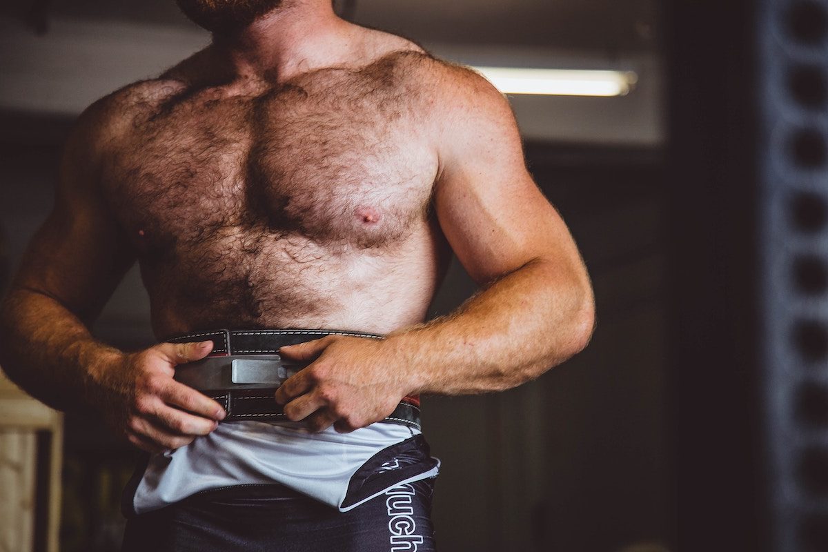 A toned man standing shirtless