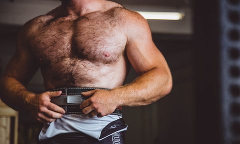 A toned man standing shirtless