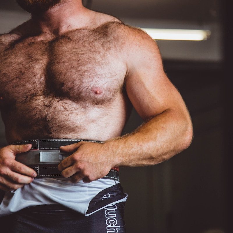 A toned man standing shirtless