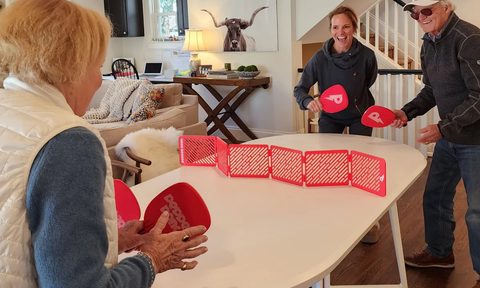 A family playing a game of pepper pong.