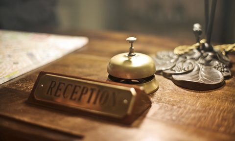 A closeup of a reception desk check in sign at a hotel