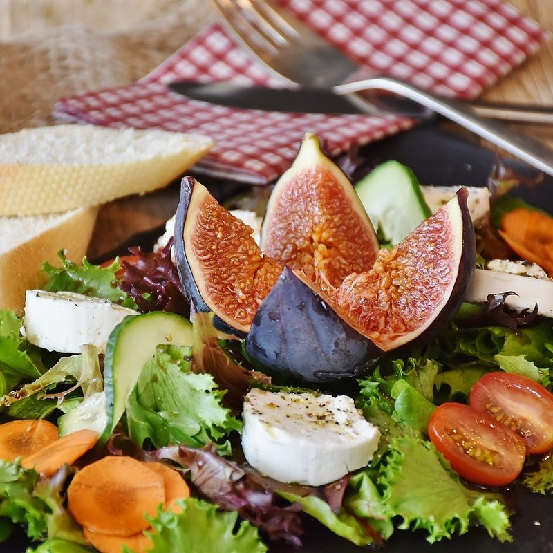Salad on plate with fig on top