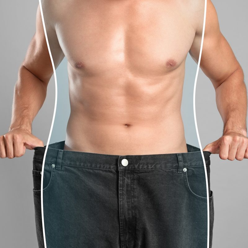 Close-up view of man with slim body in oversized jeans
