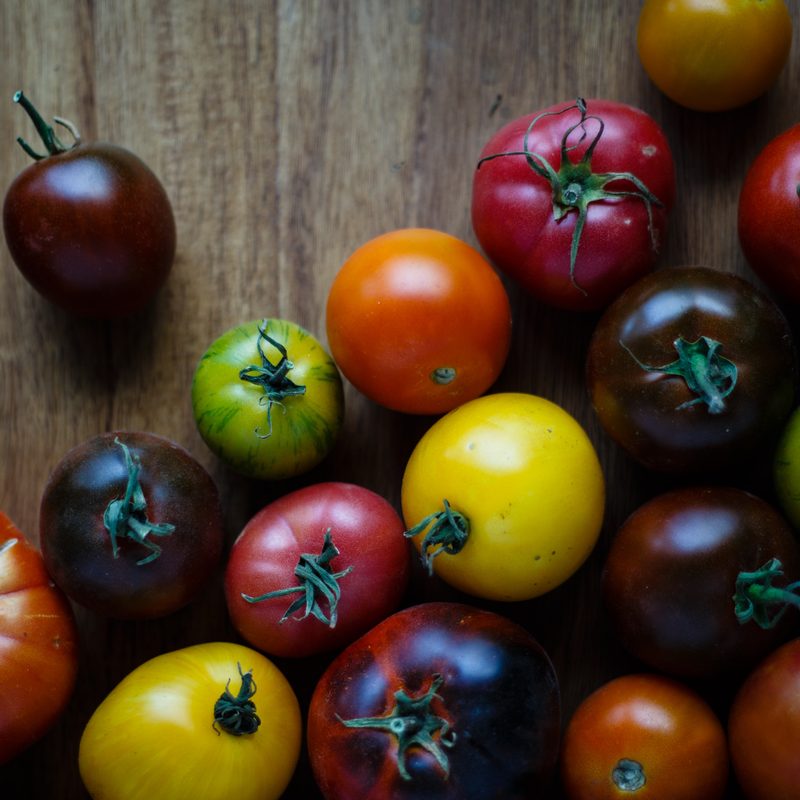 Colorful heirloom tomatoes on wooden board