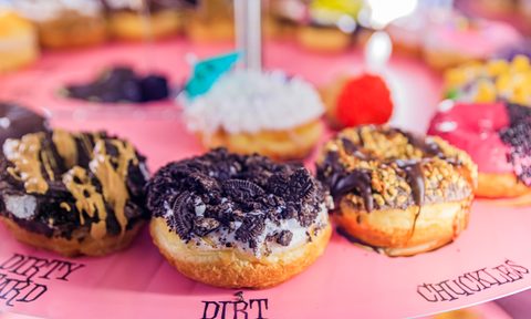 Austin, Texas, selection of donuts on display in a colorful case at Voodoo Doughnuts in a popular specialty doughnut chain shop