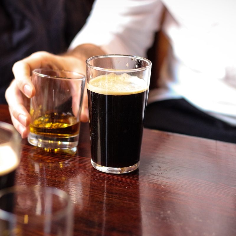 Stout on a table with another liquor