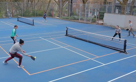 People playing pickleball outside
