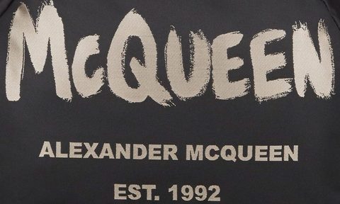 McQueen emblem on Alexander McQueen backpack.