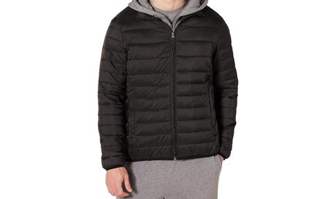 A man wearing the Amazon Essentials Men's Packable Lightweight Water-Resistant Puffer Jacket.
