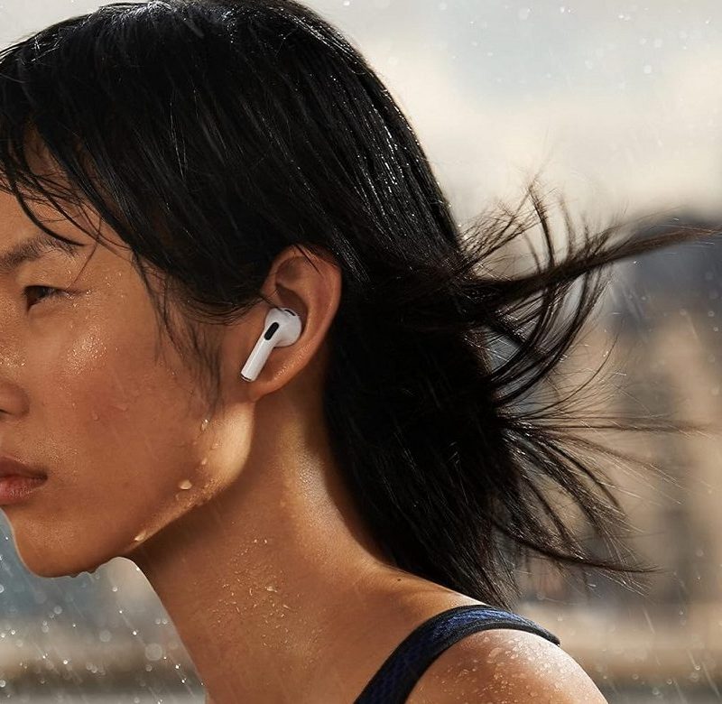 A woman wearing the Apple AirPods 3.