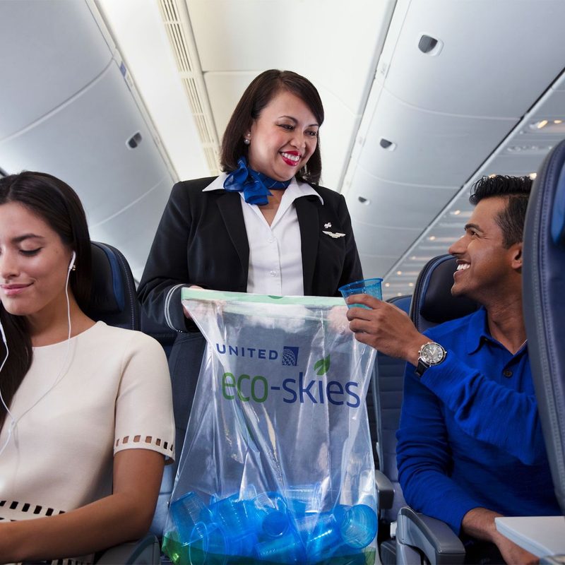 A flight attendant collects trash as part of United's Eco-Skies initiative.