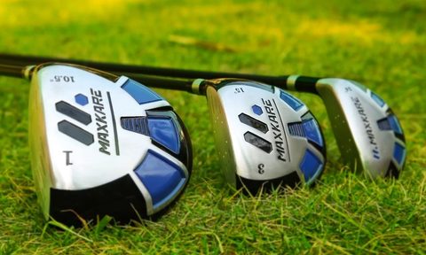 The MaxKare driver, 3-wood, and hybrid club laid out on the grass.