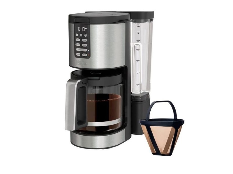 The Ninja Programmable XL 14-Cup Coffee Maker PRO with a full pot of coffee and a reusable filter on the side.