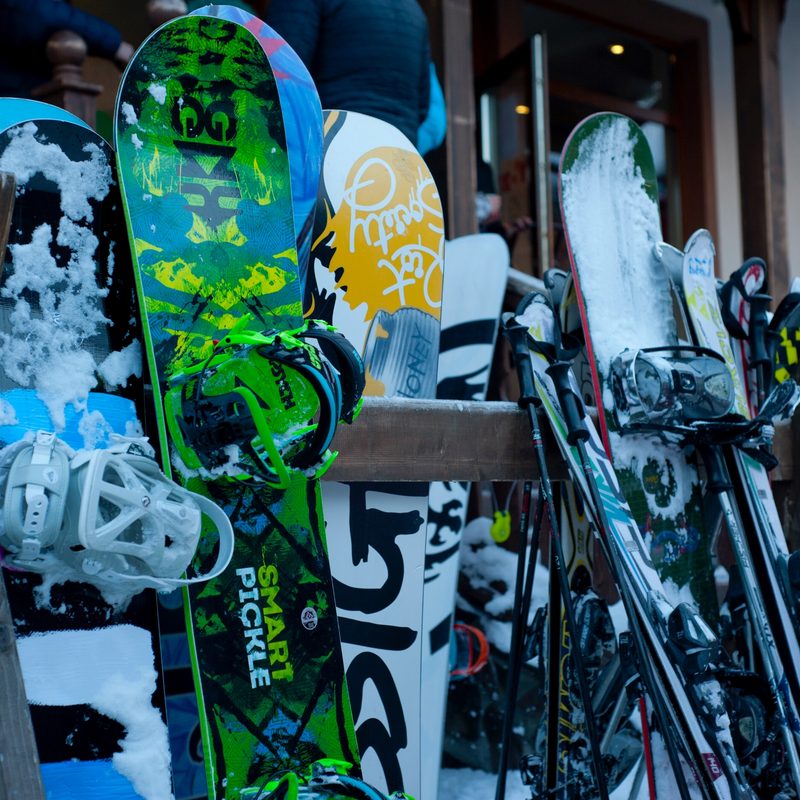 Skis and snowboards on a rack