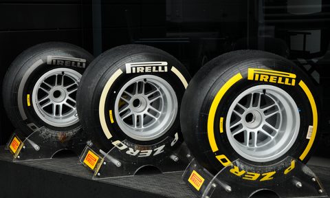 Three types of Pirelli F1 racing tires on stands.