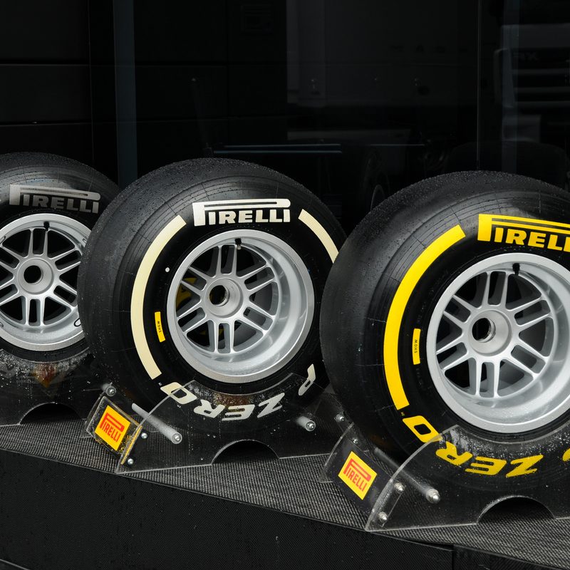 Three types of Pirelli F1 racing tires on stands.
