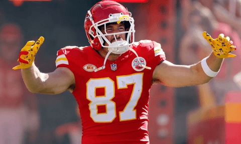Travis Kelce on the field in his trademark Kansas City Chiefs jersey, complete with helmet.