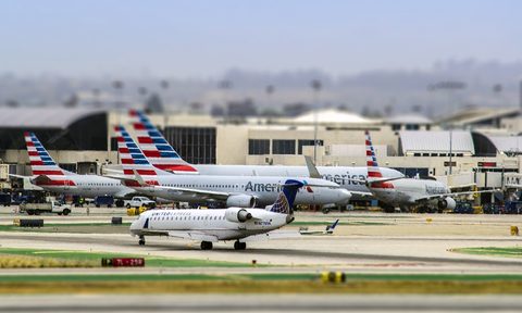 exterior of LAX airport with multiple grounded airplanes