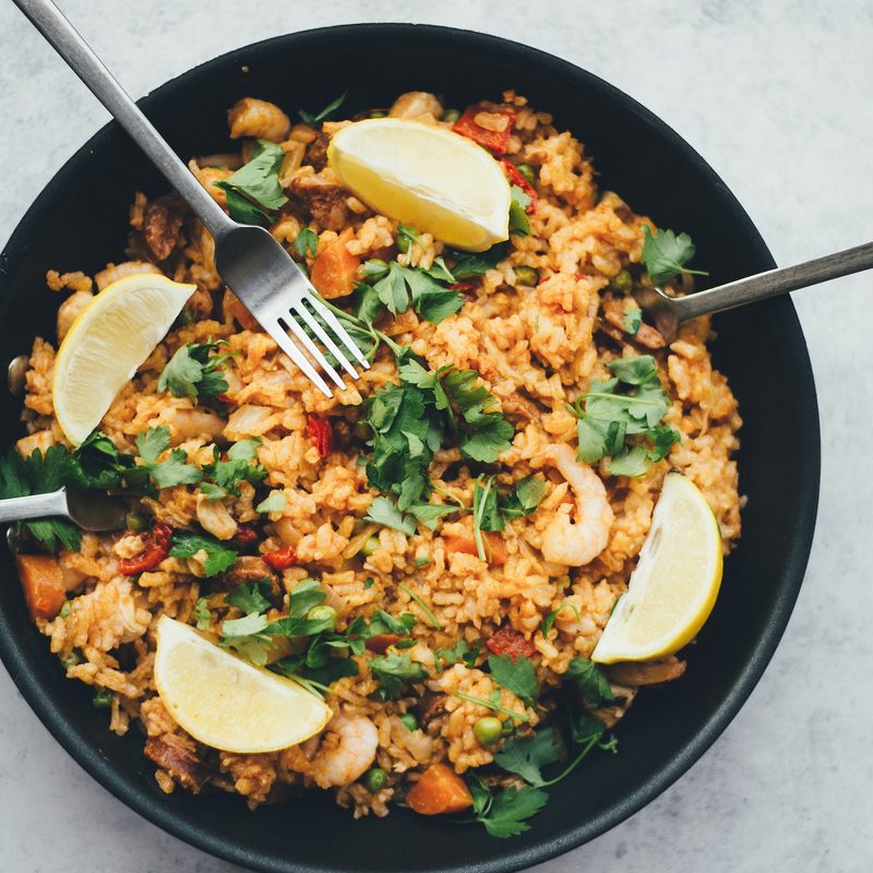 Bowl of fried rice with herbs and lemon