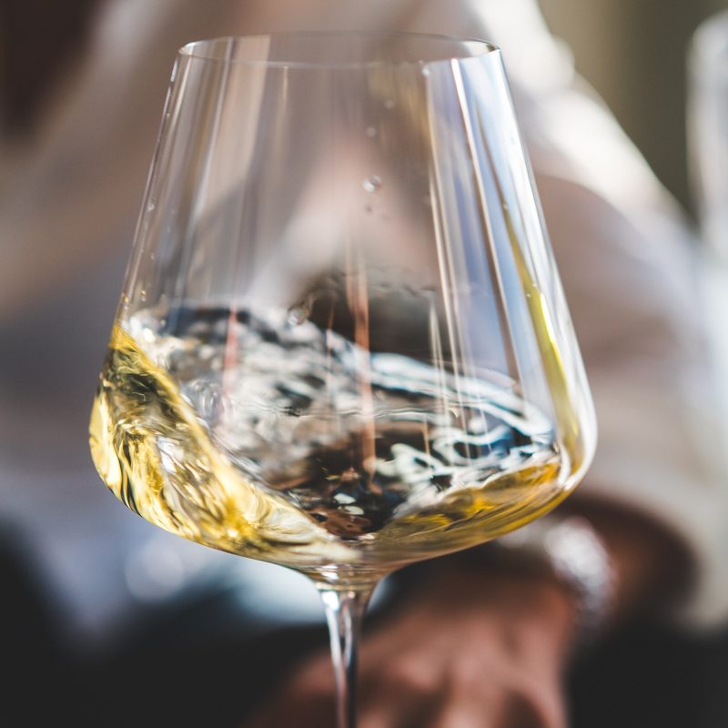 White wine in glass swirling