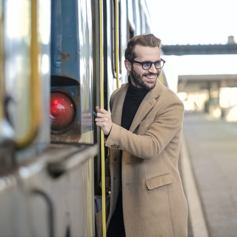 Man in cashmere coat getting on a rain