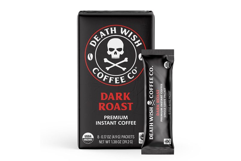 Box and packet of Death Wish Coffee Dark Roast Instant Coffee against a plain white background.