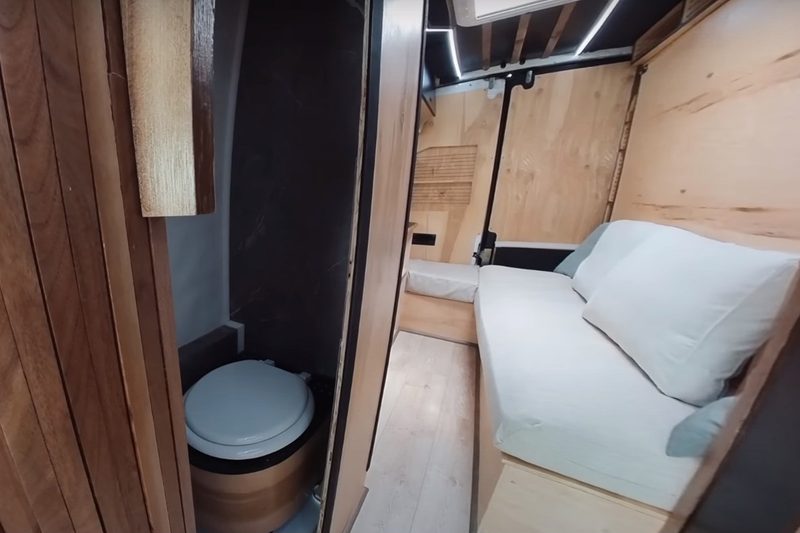 View to the bathroom and rear living/bedroom area of DualEx's custom Mercedes Sprinter campervan.