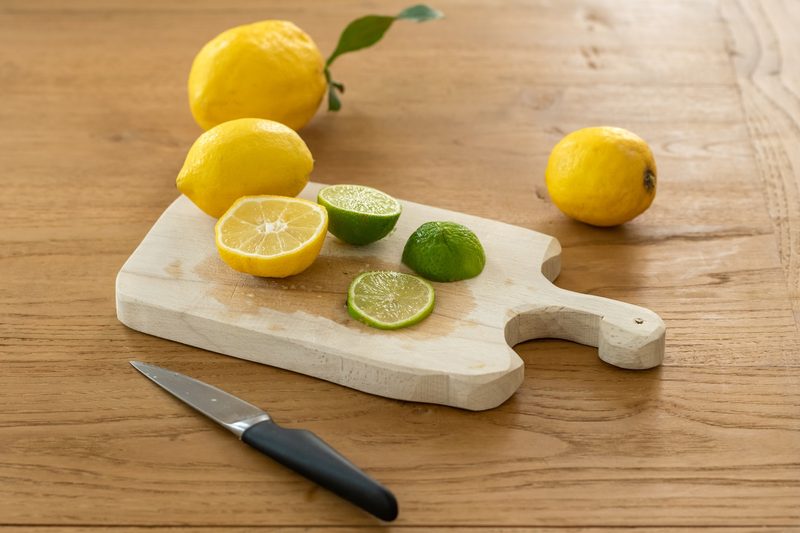 Lemon and lime on cutting baord